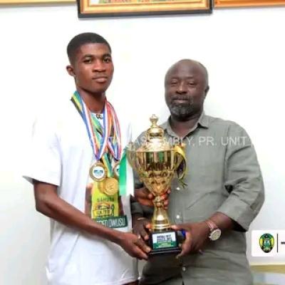 Blessed Owusu, overall best male athlete at Ashanti Regional Schools and Colleges athletics Super Zonals present medals to Kumasi Mayor